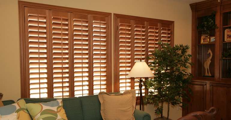 Natural wood shutters in New York City living room.